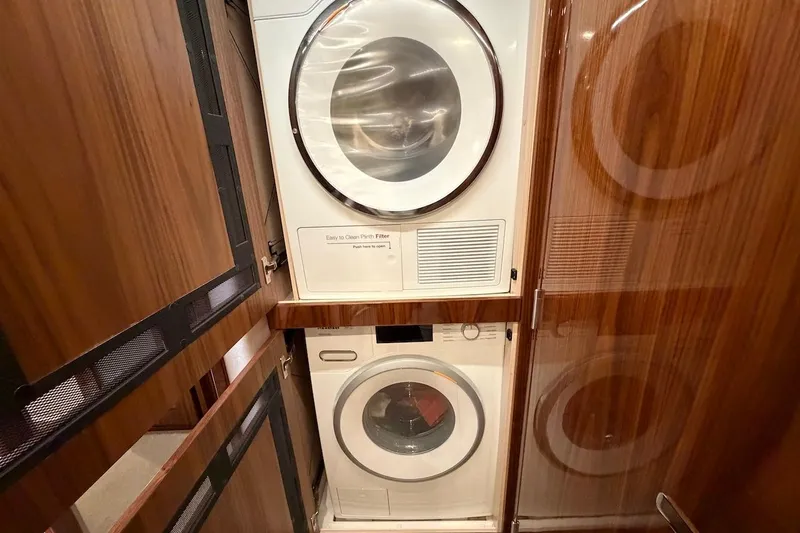  Yacht Photos Pics Laundry area in 2021 Riviera 50 Sports Motor Yacht with stacked washer and dryer.