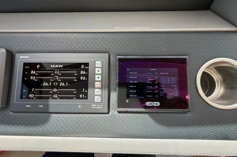  Yacht Photos Pics Control panels on 2021 Riviera 50 Sports Motor Yacht dashboard, featuring digital displays and cup holder.