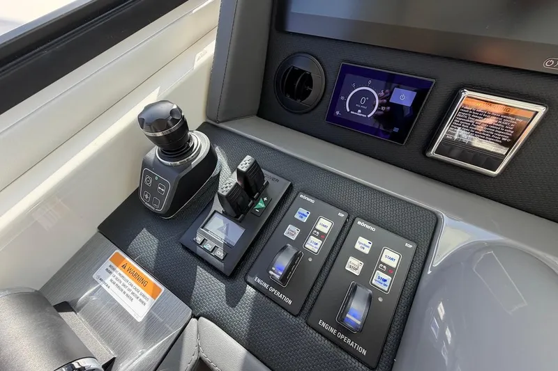  Yacht Photos Pics Control panel of 2021 Riviera 50 Sports Motor Yacht with joystick and digital display.
