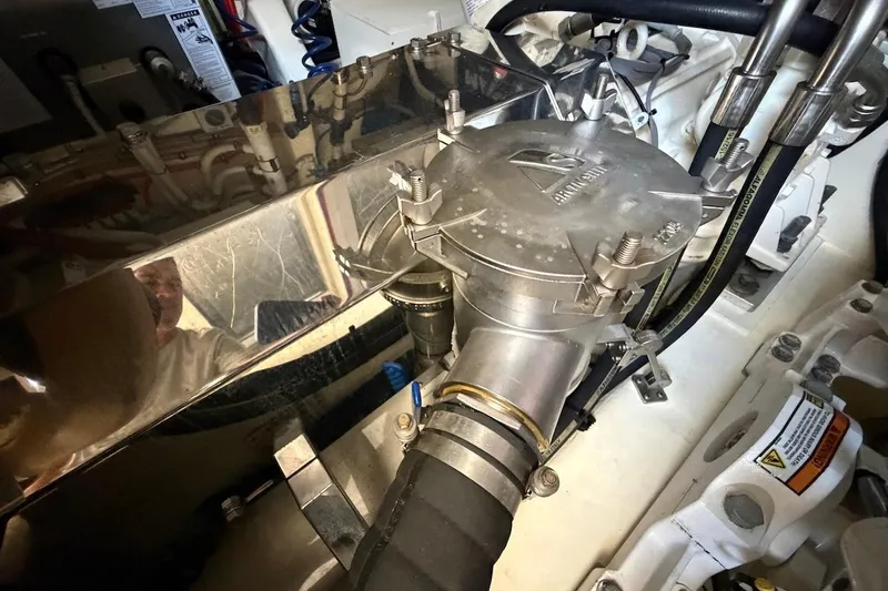  Yacht Photos Pics Engine compartment of 2021 Riviera 50 Sports Motor Yacht, showcasing mechanical components and hoses.