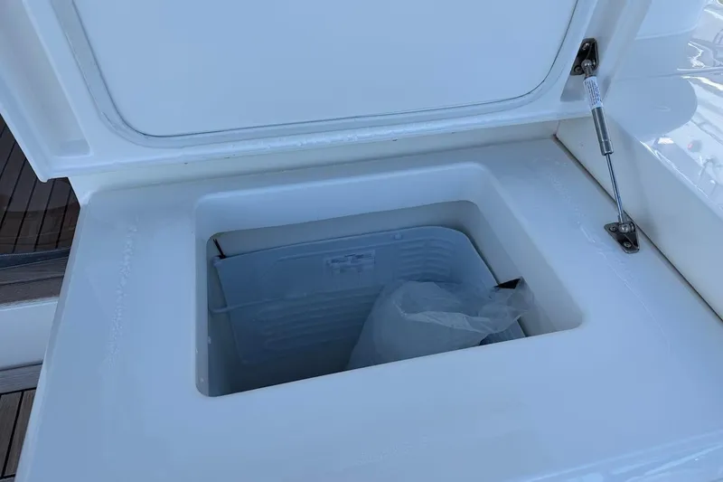  Yacht Photos Pics Open storage compartment on 2021 Riviera 50 Sports Motor Yacht, featuring a built-in cooler.