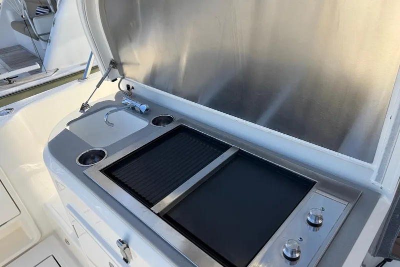  Yacht Photos Pics Outdoor kitchen on 2021 Riviera 50 Sports Motor Yacht with sink and grill.