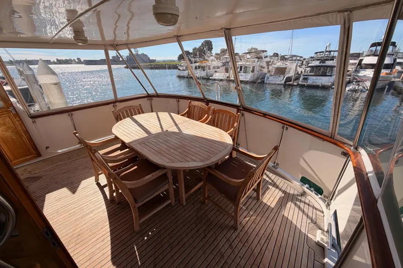 All The Way Yacht Photos Pics Spacious deck of 1984 Hartman-Palmer 60 Flush Deck Motor Yacht with wooden dining set.