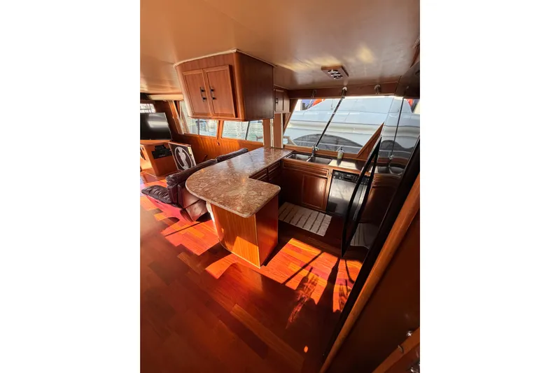 All The Way Yacht Photos Pics Interior of 1984 Hartman-Palmer 60 Flush Deck Motor Yacht with wood finishes and modern amenities.