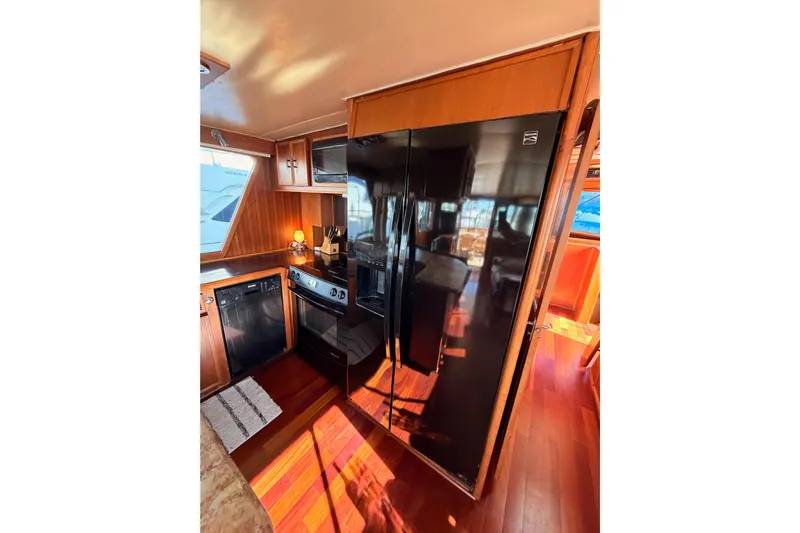All The Way Yacht Photos Pics Kitchen area of 1984 Hartman-Palmer 60 Flush Deck Motor Yacht with modern appliances.