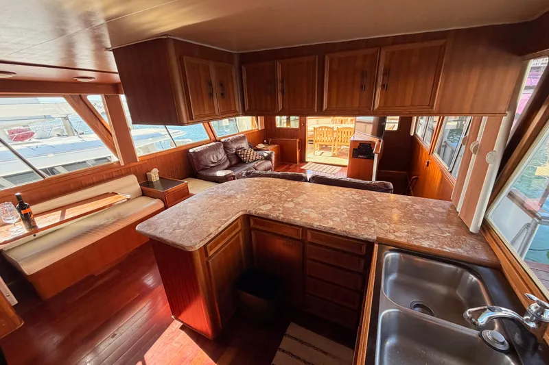 All The Way Yacht Photos Pics Interior of 1984 Hartman-Palmer 60 Flush Deck Motor Yacht with wood finishes and seating area.