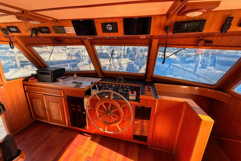 All The Way Yacht Photos Pics 1984 Hartman-Palmer 60 Flush Deck Motor Yacht helm with wooden interior and navigation equipment.