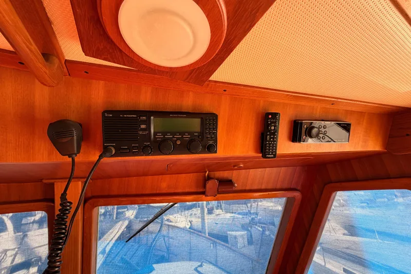 All The Way Yacht Photos Pics Interior of 1984 Hartman-Palmer yacht with radio equipment and wooden paneling.