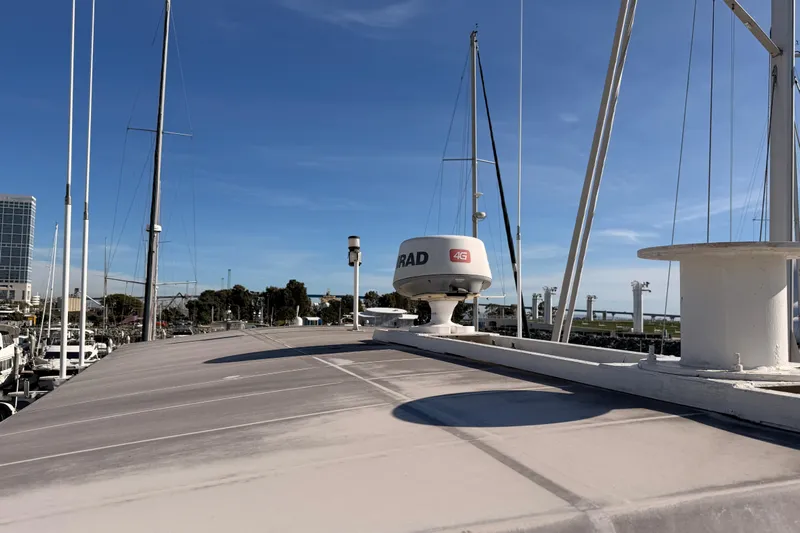 All The Way Yacht Photos Pics 1984 Hartman-Palmer 60 Flush Deck Motor Yacht with radar, docked under clear blue sky.