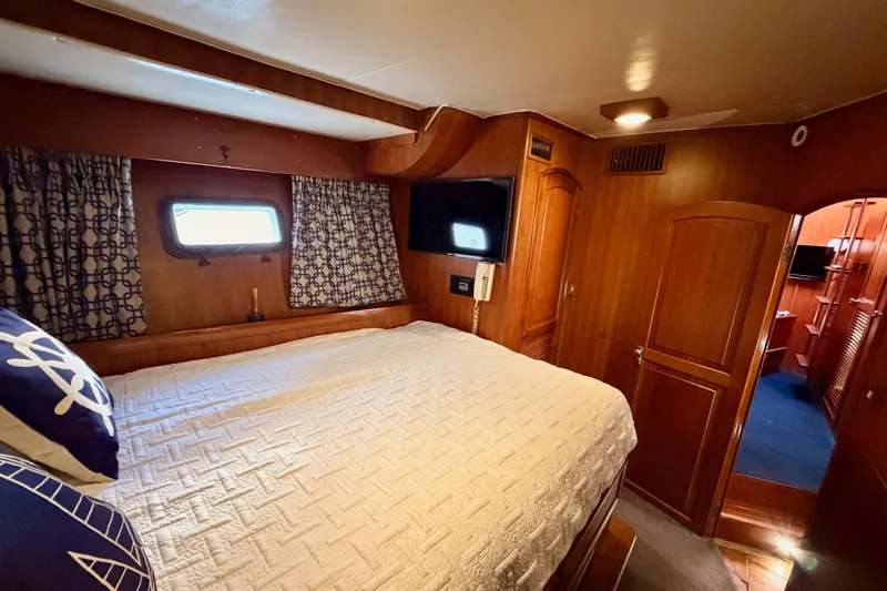 All The Way Yacht Photos Pics Cozy bedroom in 1984 Hartman-Palmer 60 Flush Deck Motor Yacht with wood paneling.