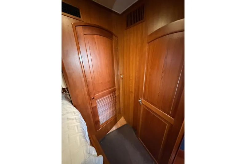 All The Way Yacht Photos Pics Wood-paneled interior of 1984 Hartman-Palmer 60 Flush Deck Motor Yacht, featuring two closed doors.