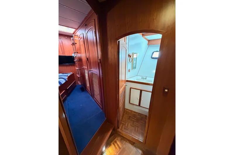 All The Way Yacht Photos Pics Interior of 1984 Hartman-Palmer 60 Flush Deck Motor Yacht, featuring wood paneling and compact bathroom.