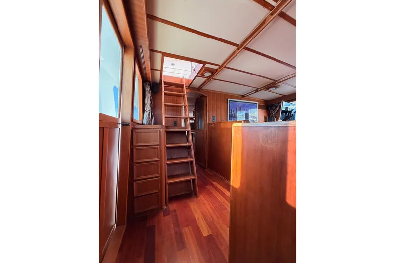 All The Way Yacht Photos Pics Interior of 1984 Hartman-Palmer 60 Flush Deck Motor Yacht with wooden stairs and paneling.