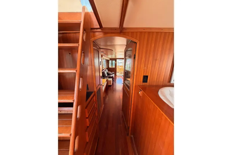 All The Way Yacht Photos Pics Interior of 1984 Hartman-Palmer 60 Flush Deck Motor Yacht with wooden finishes and cozy seating.