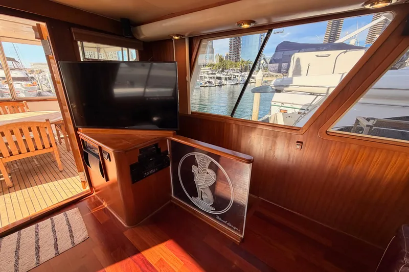 All The Way Yacht Photos Pics Interior of 1984 Hartman-Palmer 60 Flush Deck Motor Yacht with TV and marina view.