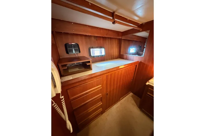 All The Way Yacht Photos Pics Interior of 1984 Hartman-Palmer 60 Flush Deck Motor Yacht with wood paneling and porthole windows.