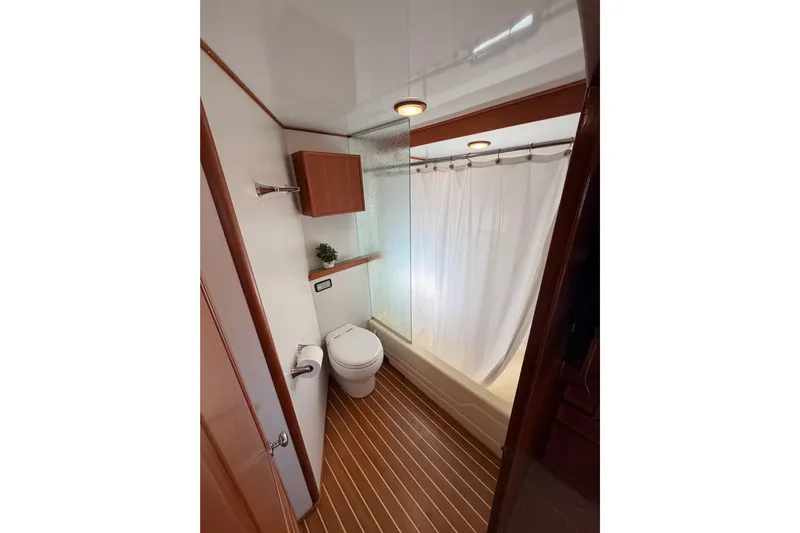 All The Way Yacht Photos Pics Bathroom interior of 1984 Hartman-Palmer 60 Flush Deck Motor Yacht, featuring shower and toilet.