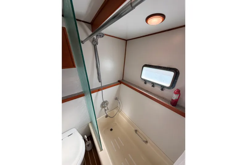 All The Way Yacht Photos Pics Bathroom interior of 1984 Hartman-Palmer 60 Flush Deck Motor Yacht, featuring shower and porthole.