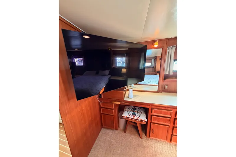 All The Way Yacht Photos Pics Interior of 1984 Hartman-Palmer 60 Flush Deck Motor Yacht with TV and wooden cabinetry.