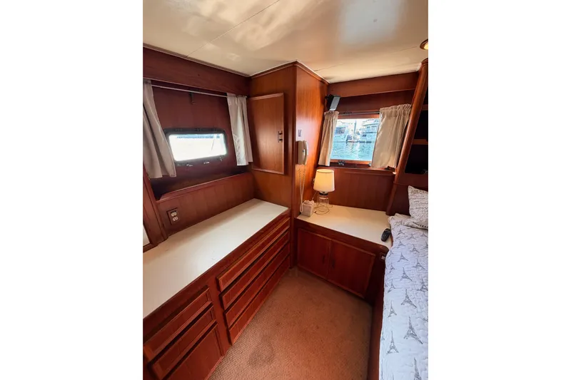 All The Way Yacht Photos Pics Interior of 1984 Hartman-Palmer 60 Flush Deck Motor Yacht, featuring wood cabinetry and cozy decor.