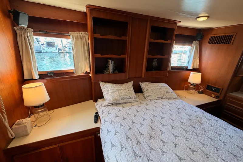 All The Way Yacht Photos Pics Cozy bedroom in 1984 Hartman-Palmer 60 Flush Deck Motor Yacht with wood paneling.