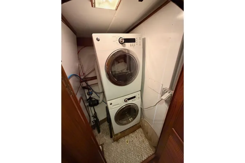 All The Way Yacht Photos Pics Laundry area with stacked washer and dryer on 1984 Hartman-Palmer 60 Flush Deck Motor Yacht.