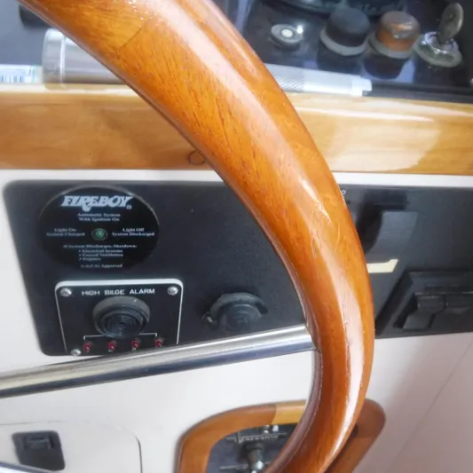 Ping Yacht Photos Pics Wooden steering wheel on 1998 Legacy 40' Flybridge yacht dashboard.