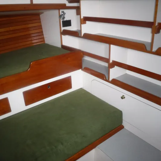 Ping Yacht Photos Pics Interior of 1998 Legacy 40' Flybridge with green cushions and wooden shelving.