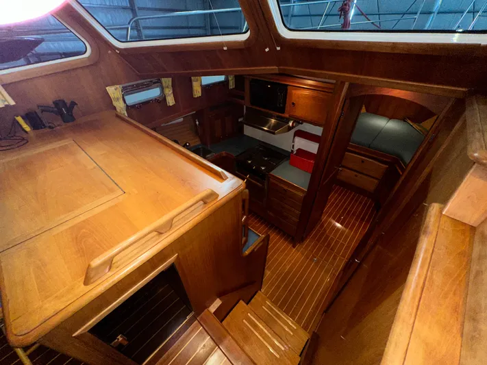  Yacht Photos Pics Interior of 2001 Sabreline 43 yacht with wooden cabinetry and cozy seating area.
