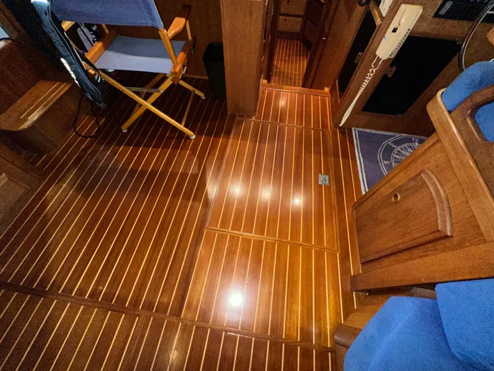  Yacht Photos Pics Polished wooden interior of 2001 Sabreline 43 yacht, featuring elegant flooring and seating.