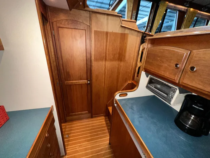  Yacht Photos Pics Interior of 2001 Sabreline 43 yacht with wooden cabinetry and blue countertops.