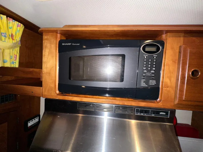  Yacht Photos Pics Microwave in 2001 Sabre Sabreline 43 yacht kitchen, wooden cabinetry, stainless steel accents.