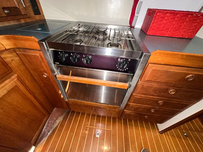  Yacht Photos Pics Wooden yacht kitchen with stainless steel stove, Sabreline 43, 2001 model.
