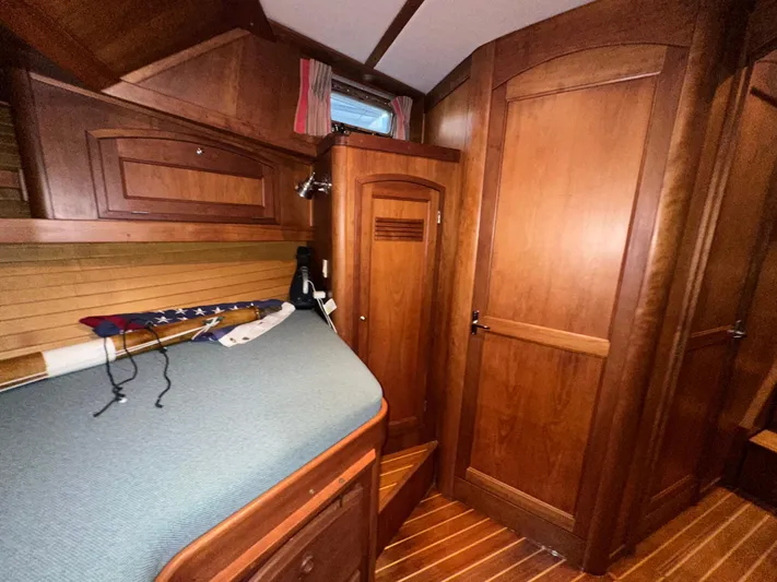  Yacht Photos Pics Interior of 2001 Sabreline 43 yacht with wooden cabinetry and cozy sleeping area.