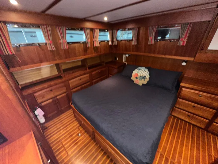  Yacht Photos Pics Luxurious wood-finished bedroom in 2001 Sabre Sabreline 43 yacht with cozy bedding.