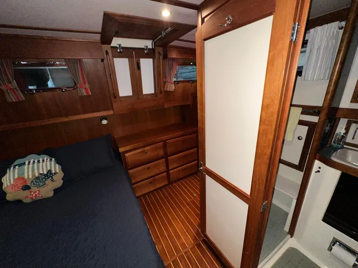  Yacht Photos Pics 2001 Sabreline 43 yacht interior with wooden cabinetry, bed, and bathroom.