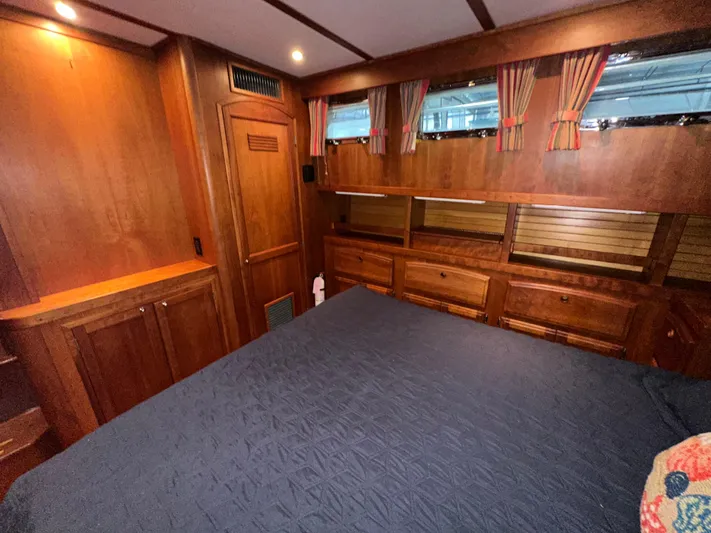  Yacht Photos Pics Luxurious wood-paneled bedroom in 2001 Sabre Sabreline 43 yacht with cozy bedding.