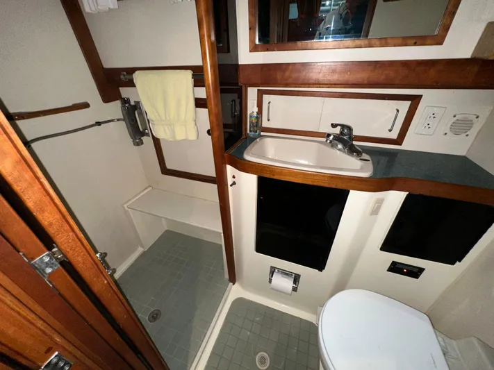  Yacht Photos Pics 2001 Sabreline 43 yacht bathroom with shower, sink, and toilet.