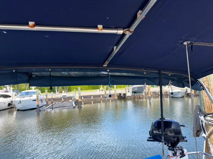 Wildflower III Yacht Photos Pics Beneteau Oceanis 45 (2016) docked, view from under blue canopy, marina background.