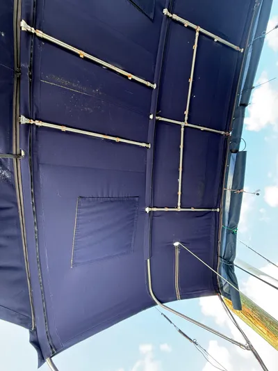 Wildflower III Yacht Photos Pics Blue canopy of a 2016 Beneteau Oceanis 45 sailboat, featuring metal support rods.