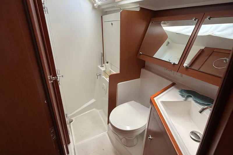 Wildflower III Yacht Photos Pics 2016 Beneteau Oceanis 45 yacht bathroom with wooden cabinetry and modern fixtures.
