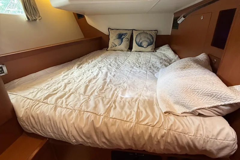 Wildflower III Yacht Photos Pics Cozy cabin bed in 2016 Beneteau Oceanis 45 yacht with shell-themed pillows.