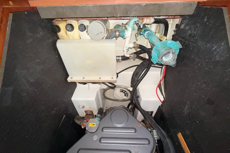 Wildflower III Yacht Photos Pics Engine compartment of a 2016 Beneteau Oceanis 45 sailboat, showing mechanical components and wiring.