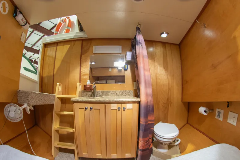 Harborviewbayview Yacht Photos Pics 1993 Custom Steel Trawler interior with wooden cabinetry and compact bathroom.