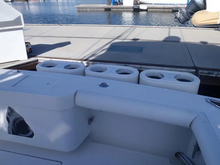 Great White Yacht Photos Pics 2001 Cabo Flybridge boat docked, featuring a shark decal and fishing rod holders.