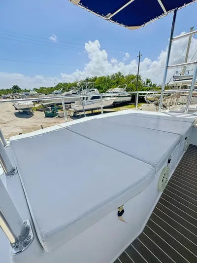 Knot Stupid Yacht Photos Pics 2005 Fountaine Pajot HIGHLAND yacht with cushioned deck, docked under clear skies.