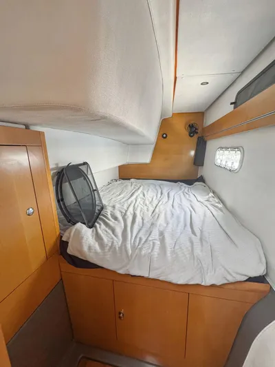 Knot Stupid Yacht Photos Pics 2005 Fountaine Pajot HIGHLAND cabin interior with bed and wooden cabinetry.