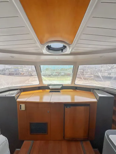 Knot Stupid Yacht Photos Pics Interior view of 2005 Fountaine Pajot HIGHLAND yacht with wooden cabinetry and panoramic windows.