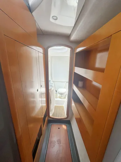 Knot Stupid Yacht Photos Pics Interior of 2005 Fountaine Pajot HIGHLAND yacht, featuring wooden cabinetry and bathroom view.