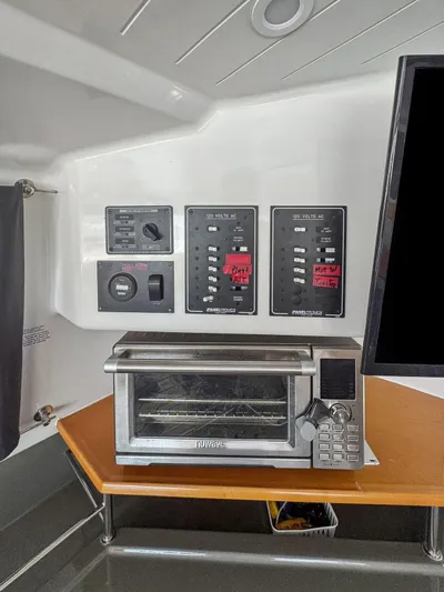 Knot Stupid Yacht Photos Pics Control panel and toaster oven inside 2005 Fountaine Pajot HIGHLAND boat interior.
